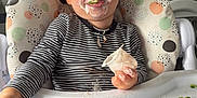 Dylan is registered to the contest to win money with this photo: toddler, child, high_chair, yogurt, messy, food, broccoli, corn, striped_shirt, face, smiling, indoor, feeding, happy, eating, hand, plastic_tray, blonde_hair, kitchen, cleaning_supplies