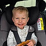 Dylan joined the competition — help win amazing prizes! blond_hair, blue_eyes, car_interior, car_seat, child, cookie, cute, hands, happy, messy_face, portrait, safety, seat, seatbelt, sitting, smile, straps, toddler, white_shirt, young_child