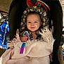 Aubrey joined the competition — help win amazing prizes! baby, infant, car_seat, blanket, toy, pop_it, floral_pattern, smiling, indoor, child, cute, happy, person, clothing, head_support, hand, blanket_texture, seat, home, playful