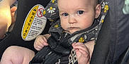 Aubrey joined the competition — help win amazing prizes! baby, car_seat, child, infant, blue_eyes, seatbelt, pacifier, floral_pattern, clothing, safety, serious_expression, indoor, car_interior, person, young_child, cute, head_support, straps, closeup, seat