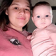 Aubrey is registered to the contest to win money with this photo: woman, baby, child, person, smiling, holding, indoor, portrait, face, clothing, pink, casual, closeup, skin, hand, head, young, cute, happy, family