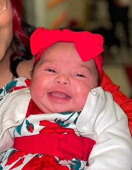 Penelope is registered to the contest to win money with this photo: baby, cheek, child, chin, event, eye, fashion_accessory, fun, happy, headwear, holiday, human_body, iris, lip, mouth, person, pink, red, skin, smile