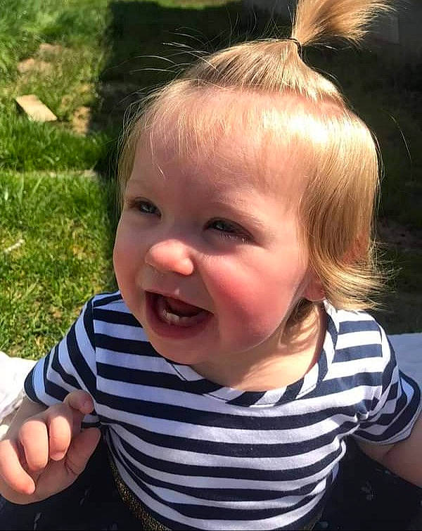 Caylee is registered to the contest to win money with this photo: baby, baby_toddler_clothing, cheek, child, chin, cool, ear, eyelash, facial_expression, gesture, grass, happy, iris, lip, mouth, nose, person, skin, sleeve, smile