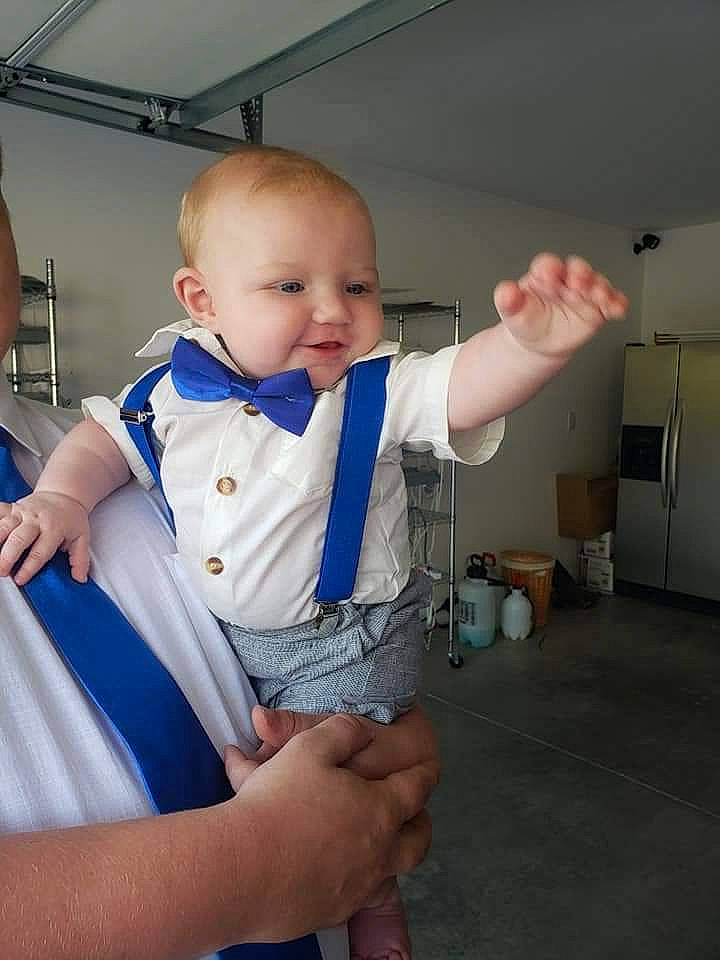 Grayson is registered to the contest to win money with this photo: arm, baby, baby_toddler_clothing, child, elbow, electric_blue, finger, fun, gesture, hairstyle, hand, joint, mouth, person, shoulder, skin, sleeve, standing, thumb, toddler