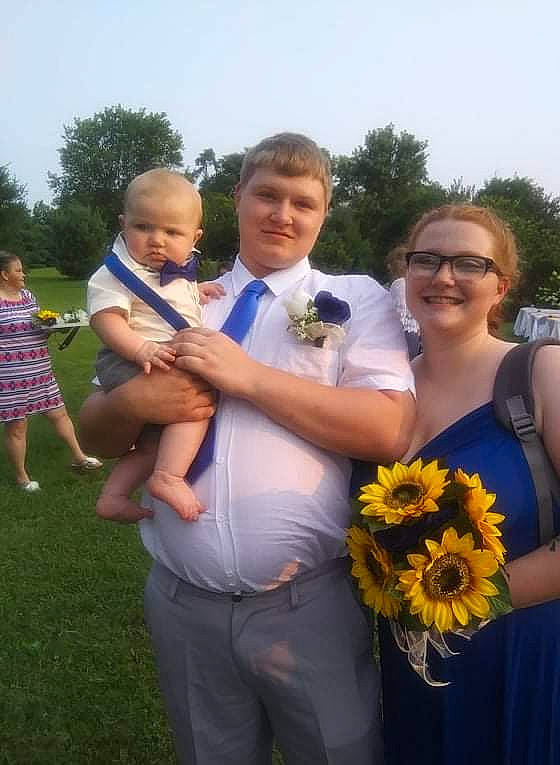 Grayson is registered to the contest to win money with this photo: blurred, bridal_clothing, clothing, dress, electric_blue, event, eyewear, flower, flower_arranging, formal_wear, fun, gesture, grass, happy, joy, people_in_nature, person, plant, shorts, sky