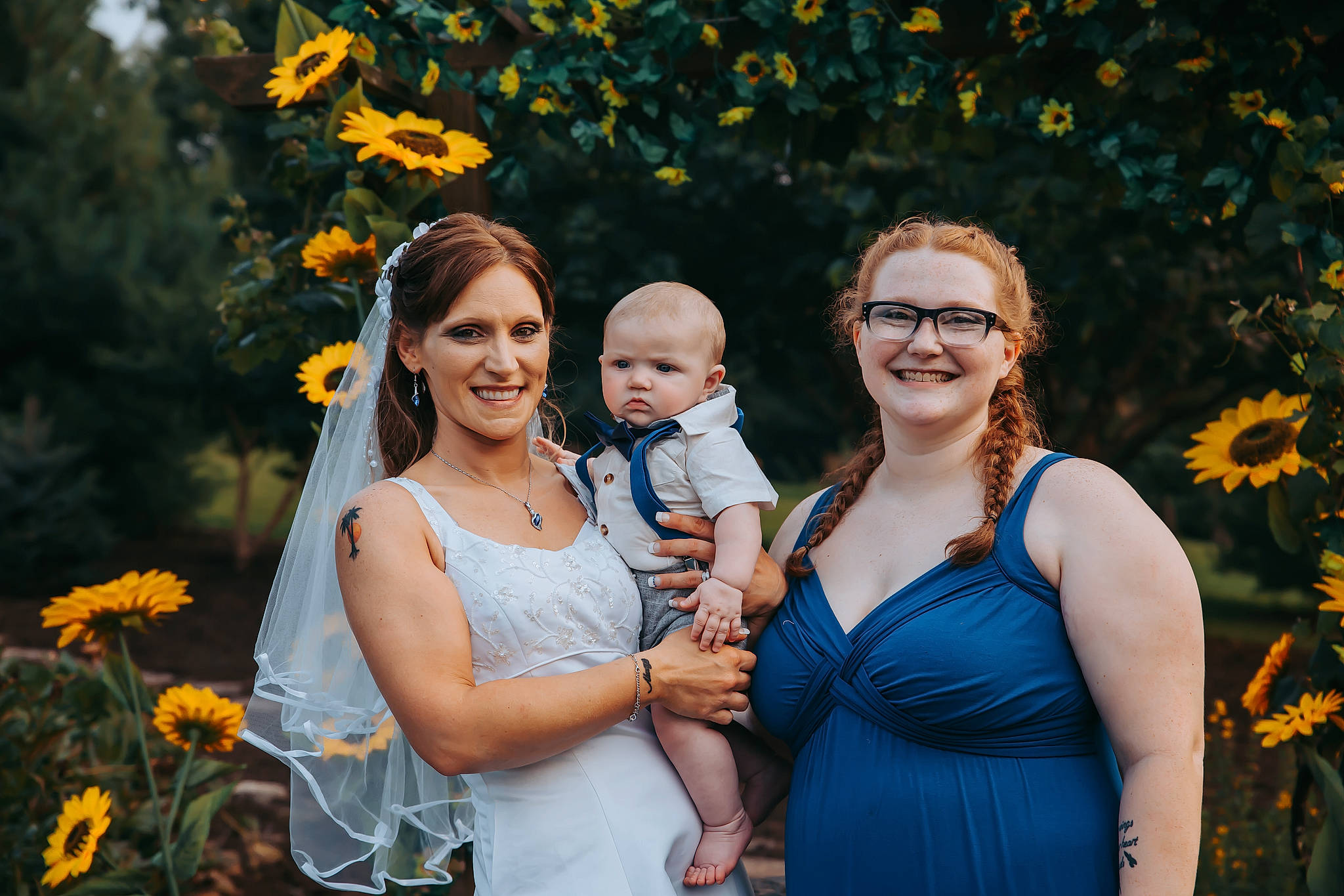 Grayson is registered to the contest to win money with this photo: baby, dress, family_taking_photos_together, flash_photography, flower, fun, grass, happy, interaction, iris, joy, leaf, leisure, nature, people, people_in_nature, person, plant, smile, standing