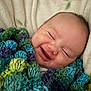 baby, smiling, blanket, knitted, colorful, face, happy, infant, cozy, cute, portrait, child, soft, warm, wrapped, sleepy, cuddly, closeup, head, peaceful