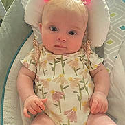 Juniper joined the competition — help win amazing prizes! baby, infant, child, pink_bows, floral_onesie, cushion, baby_chair, seated, cute, portrait, indoors, soft_light, hands, legs, expression, head_support, skin, young, small_hands, curious