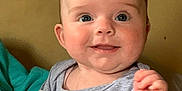 Juniper joined the competition — help win amazing prizes! baby, child, smile, blue_eyes, gray_clothing, cloud_print, tousled_hair, indoor, portrait, cute, happy, infant, person, sitting, blanket, hand, face, skin, young, cozy