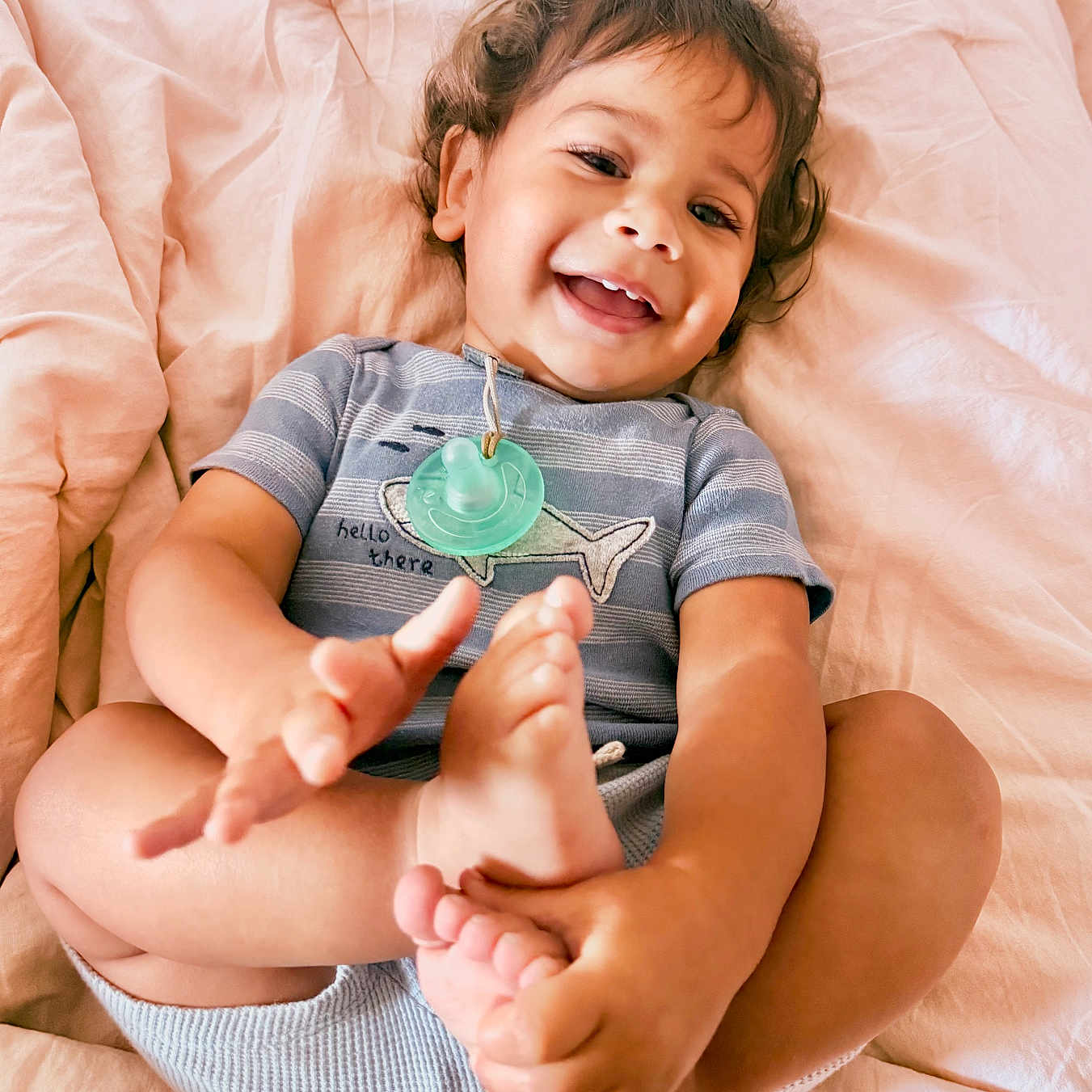 Takoah joined the competition — help win amazing prizes! baby, bed, blanket, casual, child, clothing, cute, feet, hands, happy, indoors, infant, pacifier, person, playful, portrait, skin, smiling, soft_lighting, toddler
