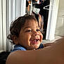 Takoah is registered to the contest to win money with this photo: toddler, child, smiling, curly_hair, indoor, closet, clothes, happy, face, person, blue_shirt, young_child, portrait, cute, baby, expression, room, door, skin, hand