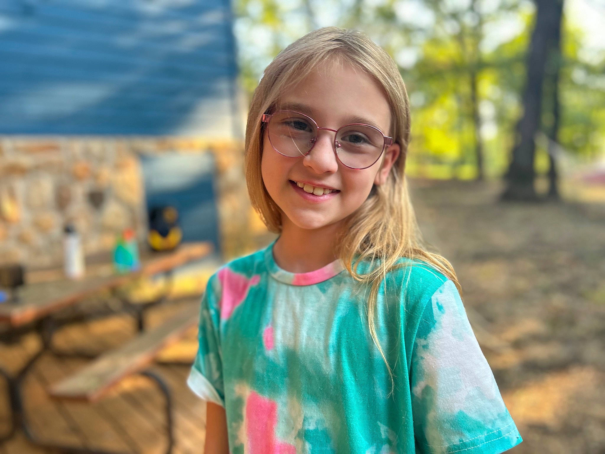 Kaitlyn is registered to the contest to win money with this photo: blond, brown_hair, child, eyewear, facial_expression, fun, glasses, grass, happy, iris, joy, leisure, people_in_nature, person, recreation, smile, soil, toddler, travel, tree