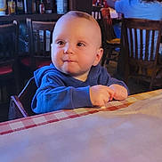 Lawson joined the competition — help win amazing prizes! background, blue_hoodie, broccoli, casual_dining, checkered_tablecloth, child, curious, expression, face, food, hands, indoor, people, plate, restaurant, seated, table, toddler, warm_lighting, wooden_chair