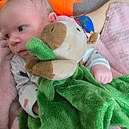 Fraya is registered to the contest to win money with this photo: baby, carpet, child, colorful, comfort, cozy, cute, fabric, foot, green_blanket, hand, indoors, infant, looking_away, person, pink_blanket, plush_toy, resting, sleepwear, soft_toy