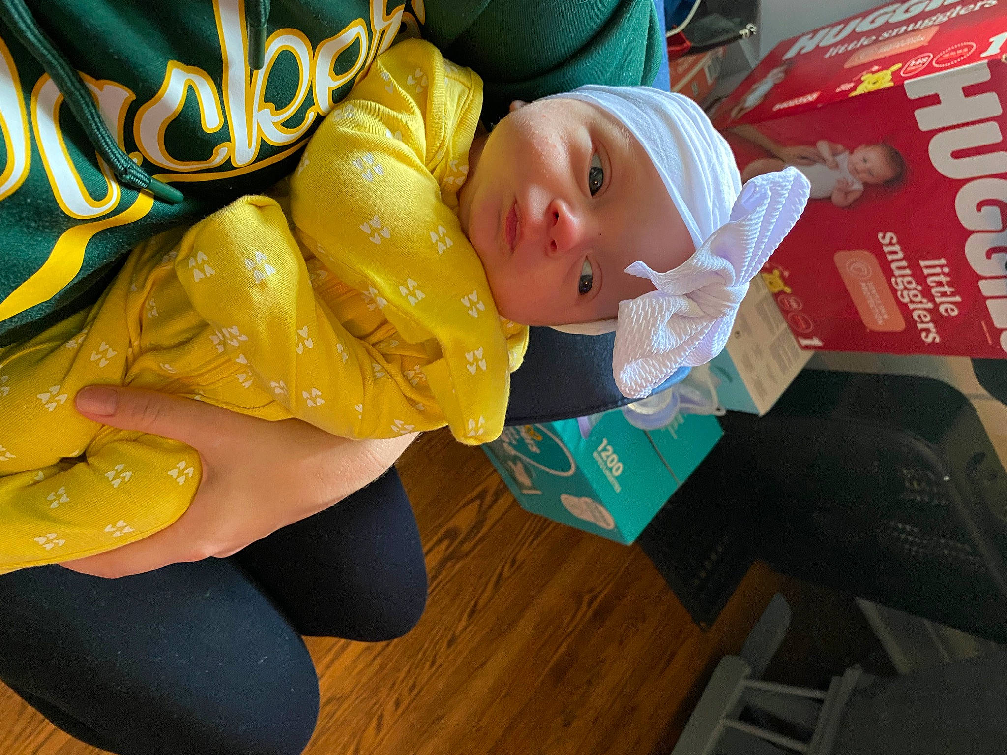 Mckenna joined the competition — help win amazing prizes! baby, baby_toddler_clothing, child, event, flooring, foot, fun, happy, hardwood, hat, headwear, human_leg, leisure, person, personal_protective_equipment, room, sitting, sportswear, thigh, toddler