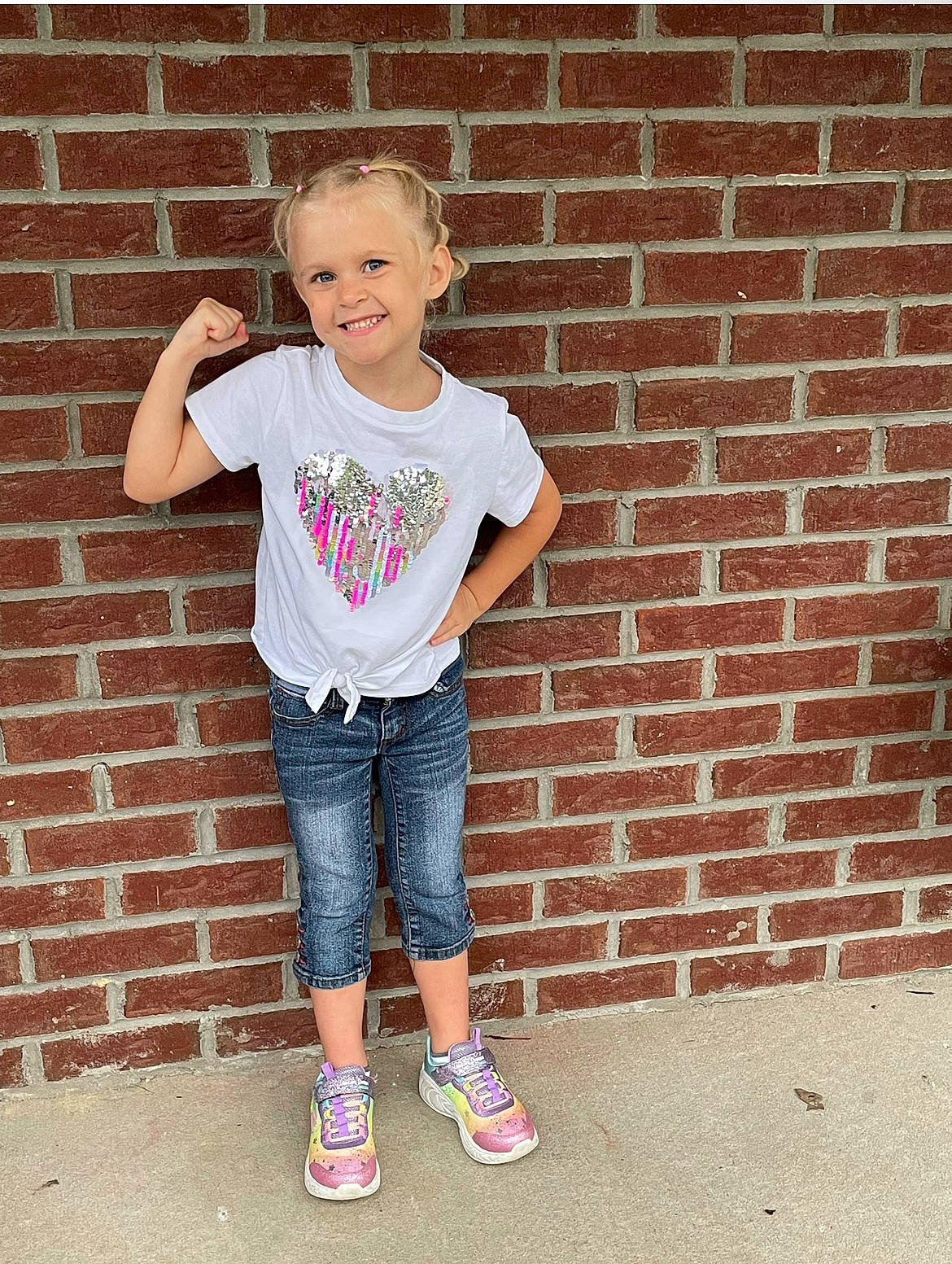 Emberlee is registered to the contest to win money with this photo: brick, brickwork, cool, denim, face, flash_photography, happy, head, jeans, joint, joy, person, pink, shoe, shoulder, sleeve, smile, sneakers, t_shirt, thigh