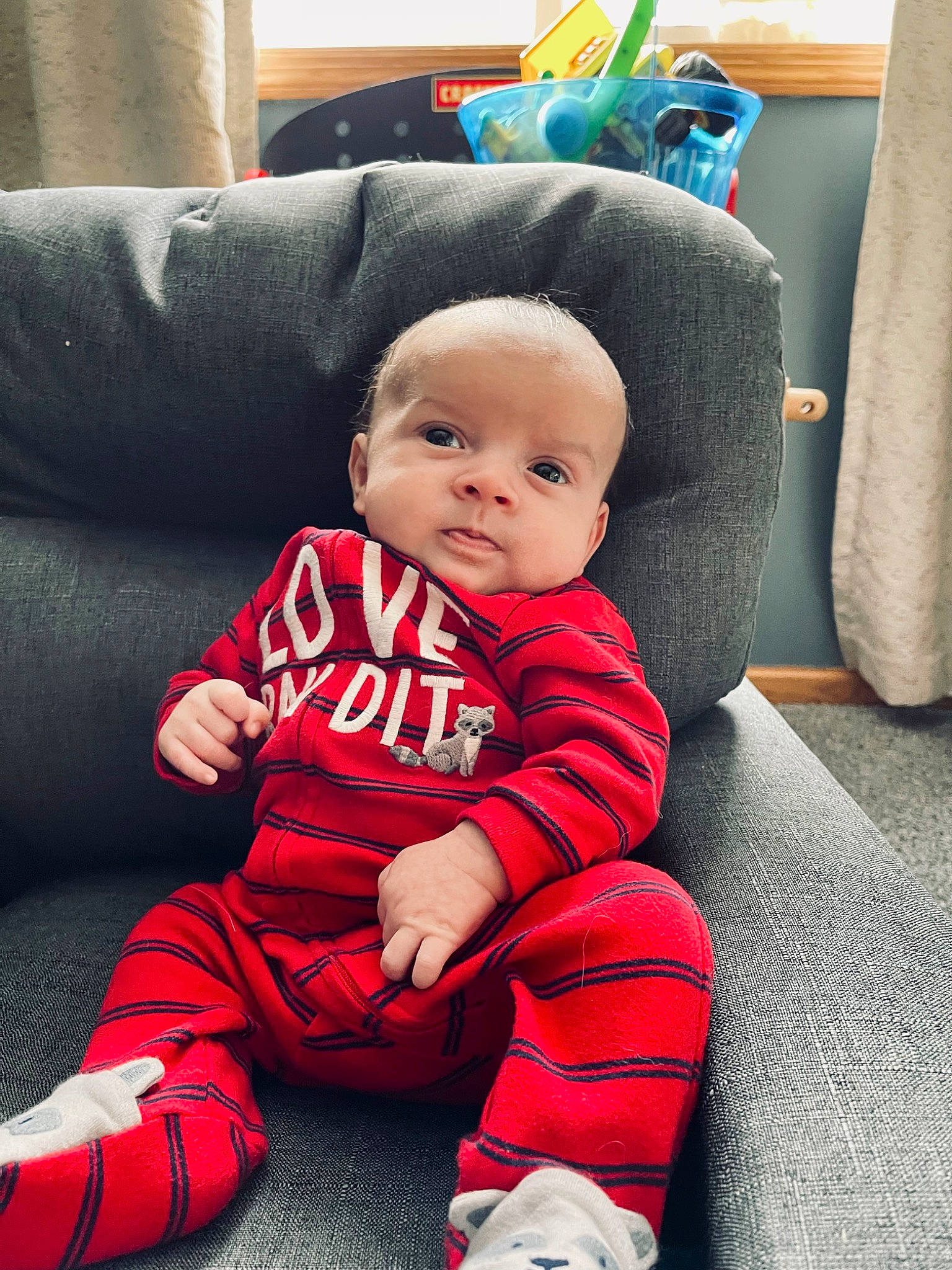 Liam joined the competition — help win amazing prizes! baby, baby_toddler_clothing, carmine, cheek, child, comfort, cool, couch, face, flooring, happy, linens, living_room, magenta, person, room, sitting, sleeve, smile, toddler