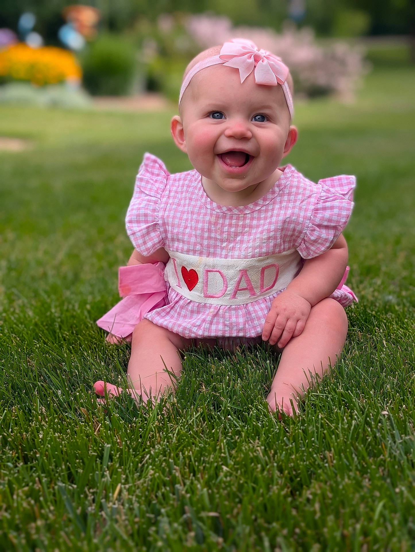 Winslette joined the competition — help win amazing prizes! baby, blue_eyes, bow, cheeks, child, cute, face, garden, grass, happy, headband, infant, nature, outdoor, pink_dress, portrait, sitting, smiling, summer, sunlight