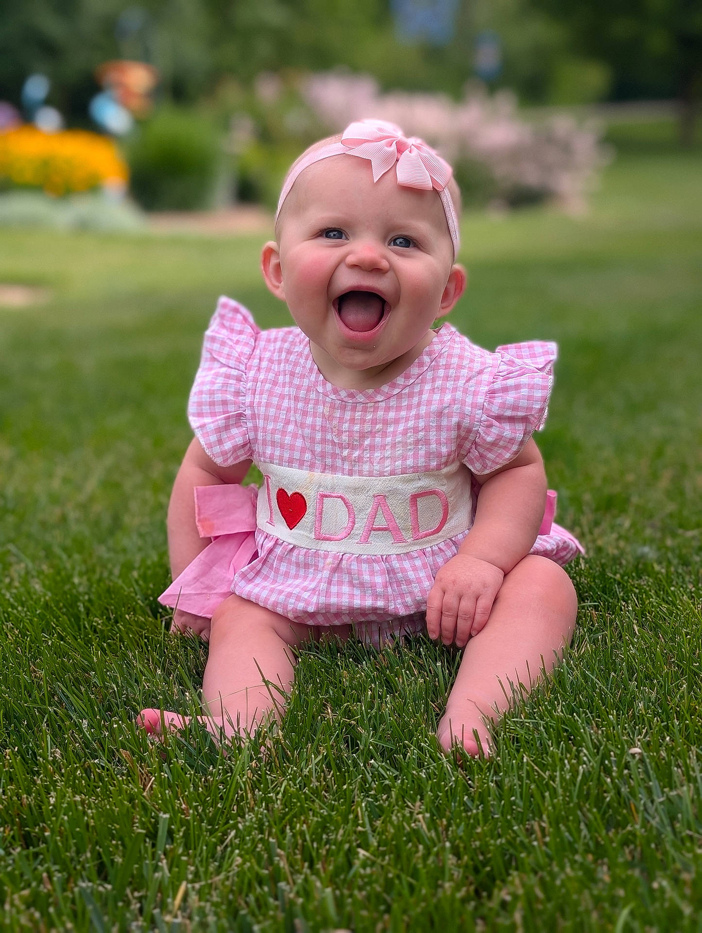 Winslette joined the competition — help win amazing prizes! baby, bow, child, cute, dress, garden, grass, green, happy, headband, infant, laughing, nature, outdoor, person, pink, portrait, sitting, smiling, sunlight