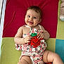 Sia participe au concours pour gagner de l'argent avec cette photo : baby, smiling, toy, plush, colorful_blanket, happy, child, cute, infant, clothing, patterned_outfit, lying_down, playtime, indoors, skin, person, hand, legs, face, joyful