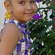 Jazelle joined the competition — help win amazing prizes! child, girl, curly_hair, smile, purple_flowers, floral_top, purple_skirt, outdoor, plants, greenery, portrait, happy, cute, nature, garden, face, person, young, fashion, summer