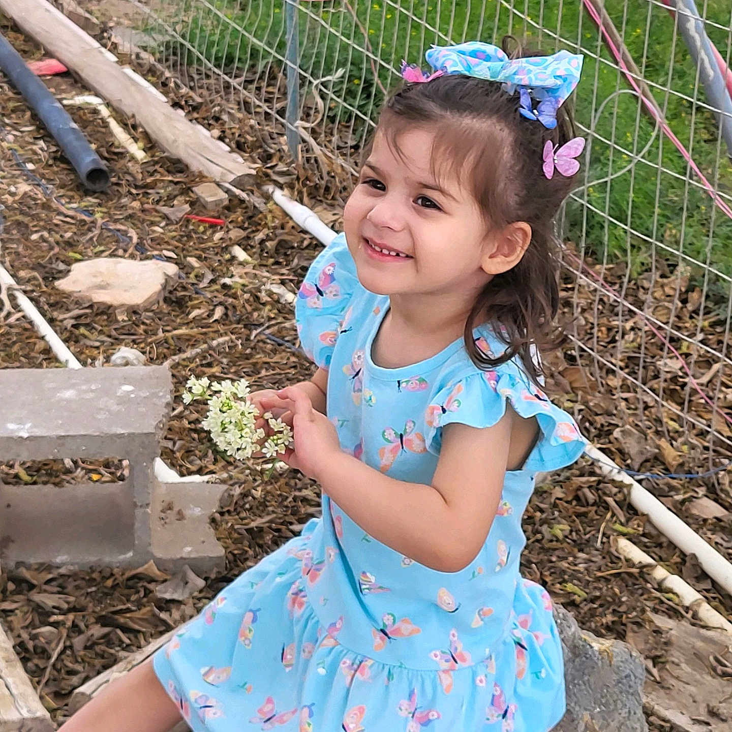 Finnlei is registered to the contest to win money with this photo: backyard, child, clothing, dress, face, female, fence, footwear, girl, grass, head, nature, outdoors, person, photography, plant, portrait, shoe, soil, yard