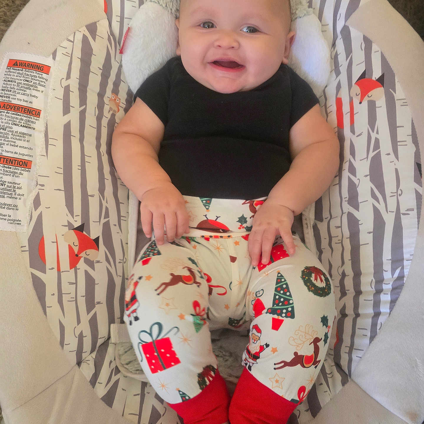 Grayson is registered to the contest to win money with this photo: baby, baby_chair, black_shirt, carpet, child, christmas_pants, cute, face, feet, fox_pattern, hands, happy, head, holiday_theme, indoor, infant, plush, sitting, smiling, woodland_pattern