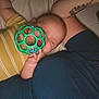 Grayson joined the competition — help win amazing prizes! baby, sleeping, toy, green, arm, tattoo, yellow_striped_shirt, closeup, indoor, person, child, hand, face, nap, resting, skin, comfort, cuddle, infant, peaceful