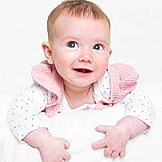 Penelope joined the competition — help win amazing prizes! baby, infant, smiling, cute, polka_dot, white_background, pink_vest, blanket, hands, face, portrait, child, happy, closeup, soft_texture, studio, clothing, light_skin, short_hair, bright_eyes