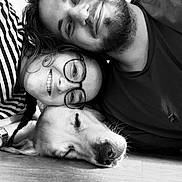Bambou participe au concours pour gagner de l'argent avec cette photo : black_and_white, smiling, glasses, beard, dog, sleeping, human, closeup, portrait, floor, striped_shirt, casual_clothing, happy, laying_down, indoors, friendship, relaxation, hair, face, nose