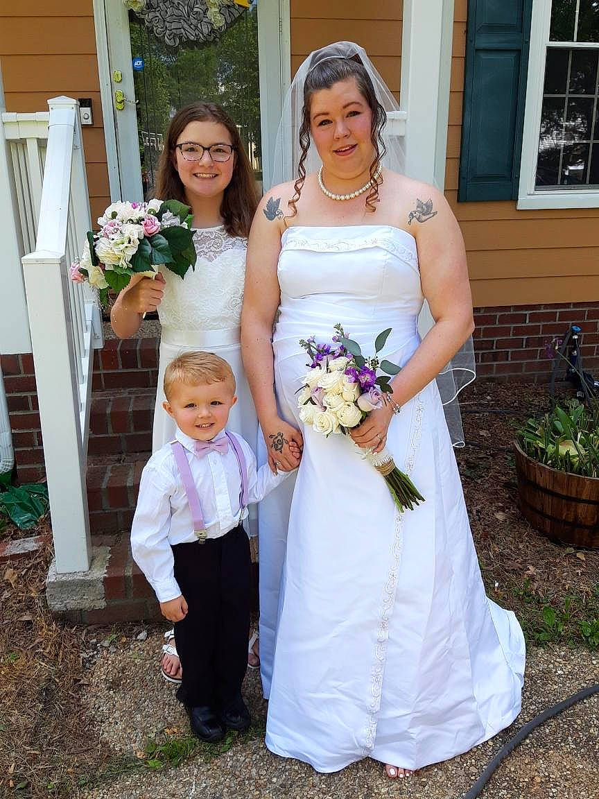 J.j. is registered to the contest to win money with this photo: bouquet, bridal_accessory, bridal_clothing, bridal_party_dress, bride, ceremony, child, dress, event, floristry, formal_wear, gown, happy, joy, marriage, person, photograph, smile, wedding, wedding_ceremony_supply