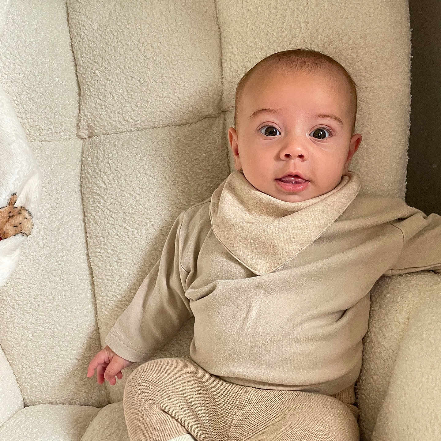 Ovi joined the competition — help win amazing prizes! armchair, baby, baby_socks, beige_clothing, child, comfortable, cozy, cute, home, indoor, infant, knit_pants, neutral_colors, plush, portrait, relaxed, sitting, soft_texture, tongue_out, wide_eyes