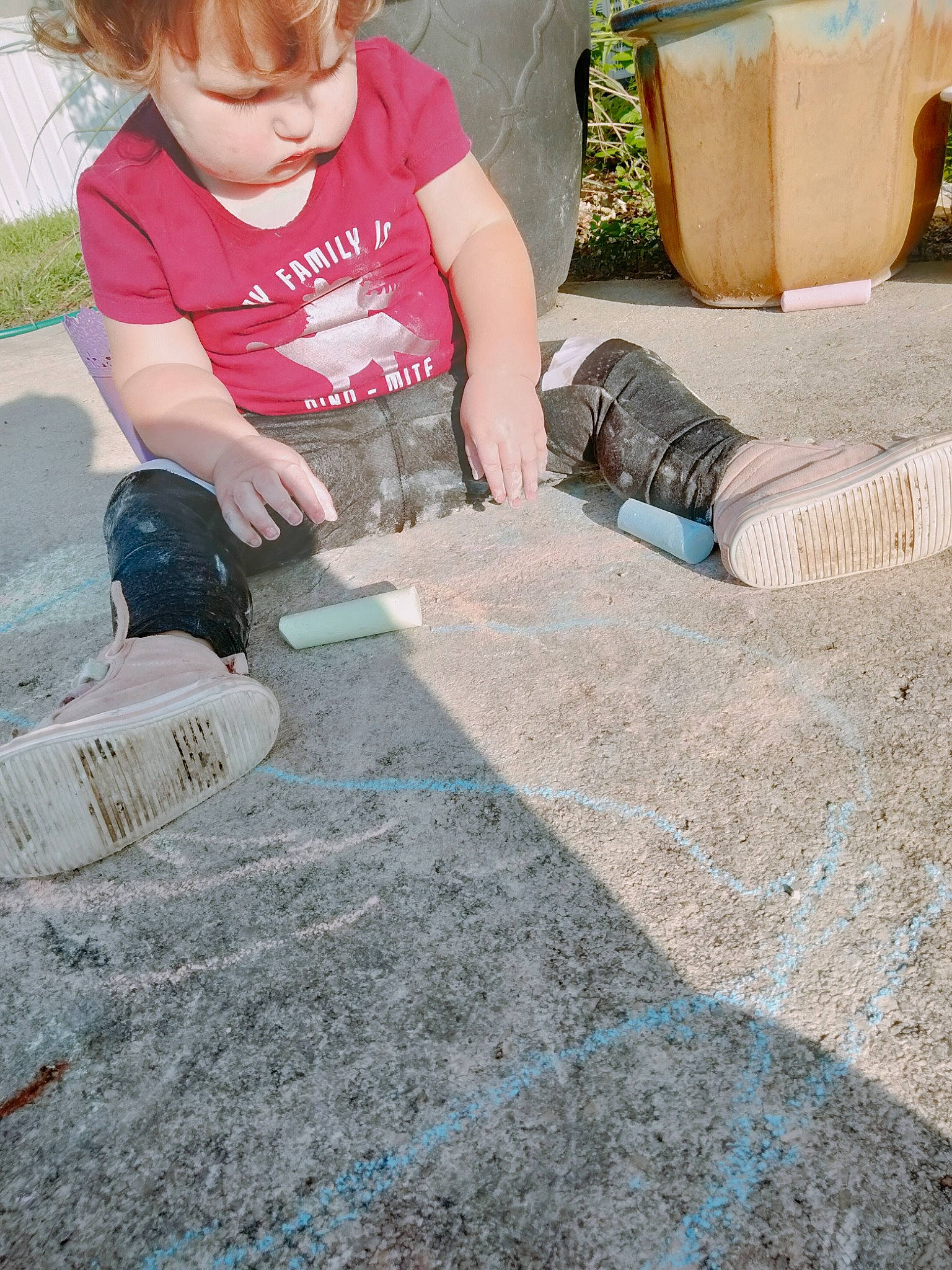 Lilly is registered to the contest to win money with this photo: art, asphalt, child, concrete, flooring, fun, grass, leisure, person, plant, recreation, road_surface, sand, sidewalk, sitting, soil, summer, t_shirt, toddler, tree