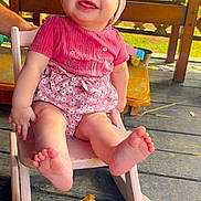 Kimber is registered to the contest to win money with this photo: baby, barefoot, child, cute, foot, happy, headband, infant, nature, outdoor, pink_clothing, playground, portrait, rocking_chair, seat, smiling, summer, sunlight, toy, wooden_floor