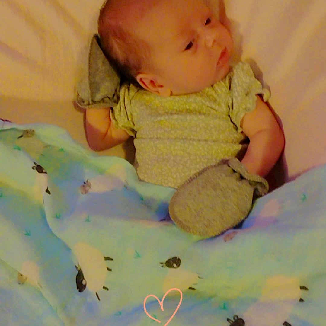 Lydia joined the competition — help win amazing prizes! baby, bed, blanket, child, comfort, cozy, cute, indoors, infant, lying_down, mittens, pattern, pink_heart, portrait, resting, sheep, sleep, sleepwear, soft_toys, warm