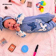 Dailanys joined the competition — help win amazing prizes! baby, infant, blue_outfit, butterfly_pattern, headband, smiling, lying_down, blanket, makeup_brush, makeup_compact, lipstick, baby_toy, colorful, cute, happy, soft_texture, closeup, indoors, child, playful