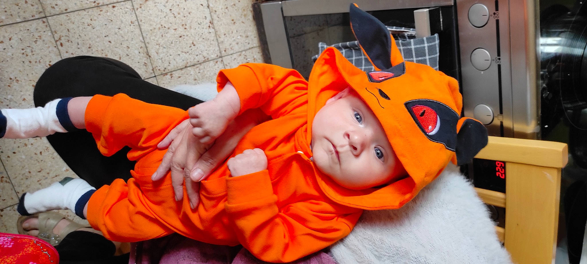 Kyle participe au concours pour gagner de l'argent avec cette photo : audio_equipment, baby, baby_toddler_clothing, child, comfort, costume, eye, fun, headwear, home_appliance, kitchen_appliance, mouth, orange, person, personal_protective_equipment, room, sitting, toddler, trick_or_treat, vacation