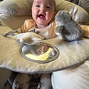 Aoife joined the competition — help win amazing prizes! baby, smiling, infant, soft_toys, mirror, cushion, cozy, indoor, clothing, person, cute, happy, seat, plush, fabric, legs, head, face, home, comfort