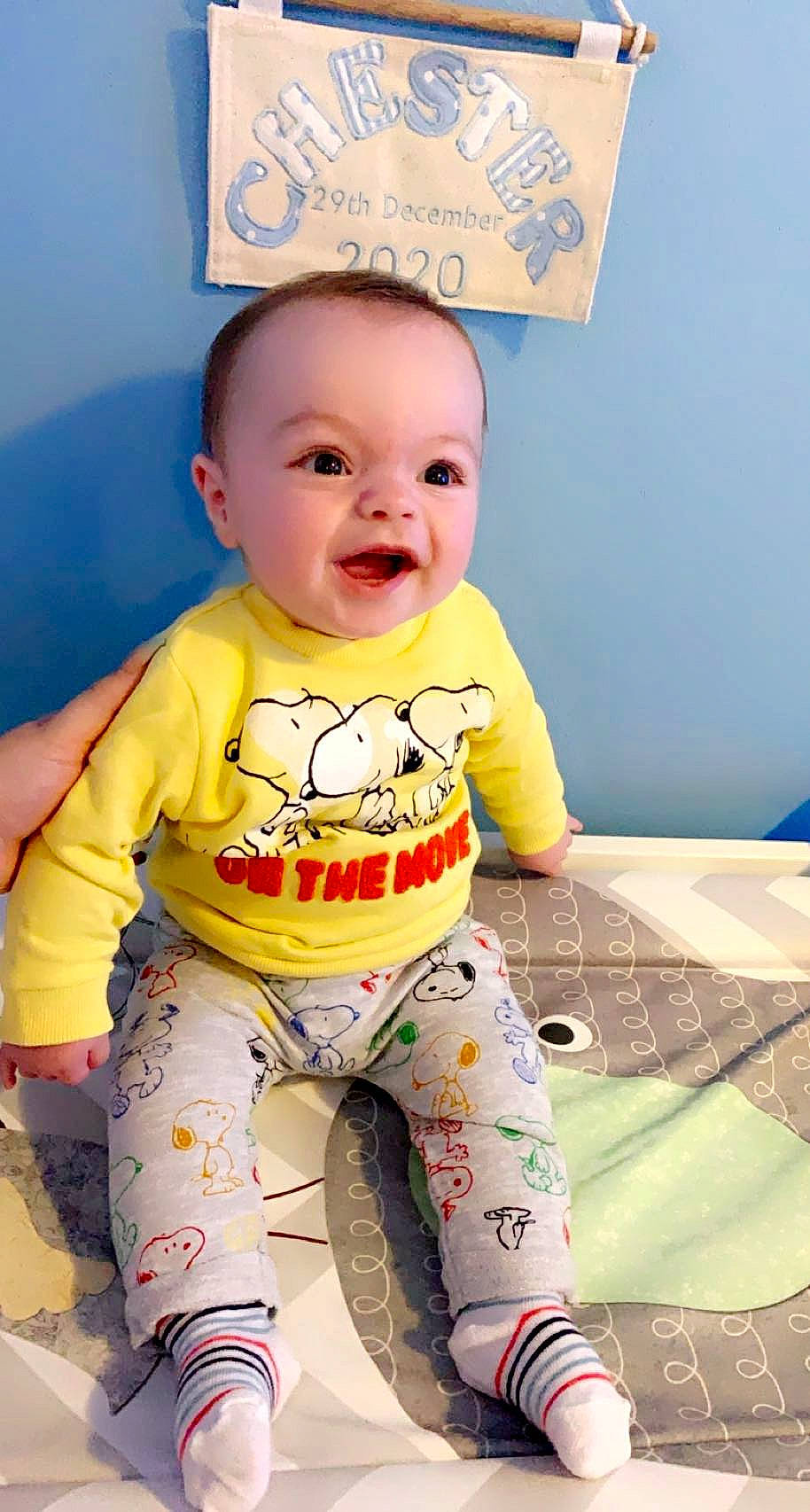 Chester is registered to the contest to win money with this photo: arm, baby, baby_toddler_clothing, cheek, child, chin, eye, face, flooring, hairstyle, happy, head, person, pink, skin, sleeve, smile, sportswear, t_shirt, toddler