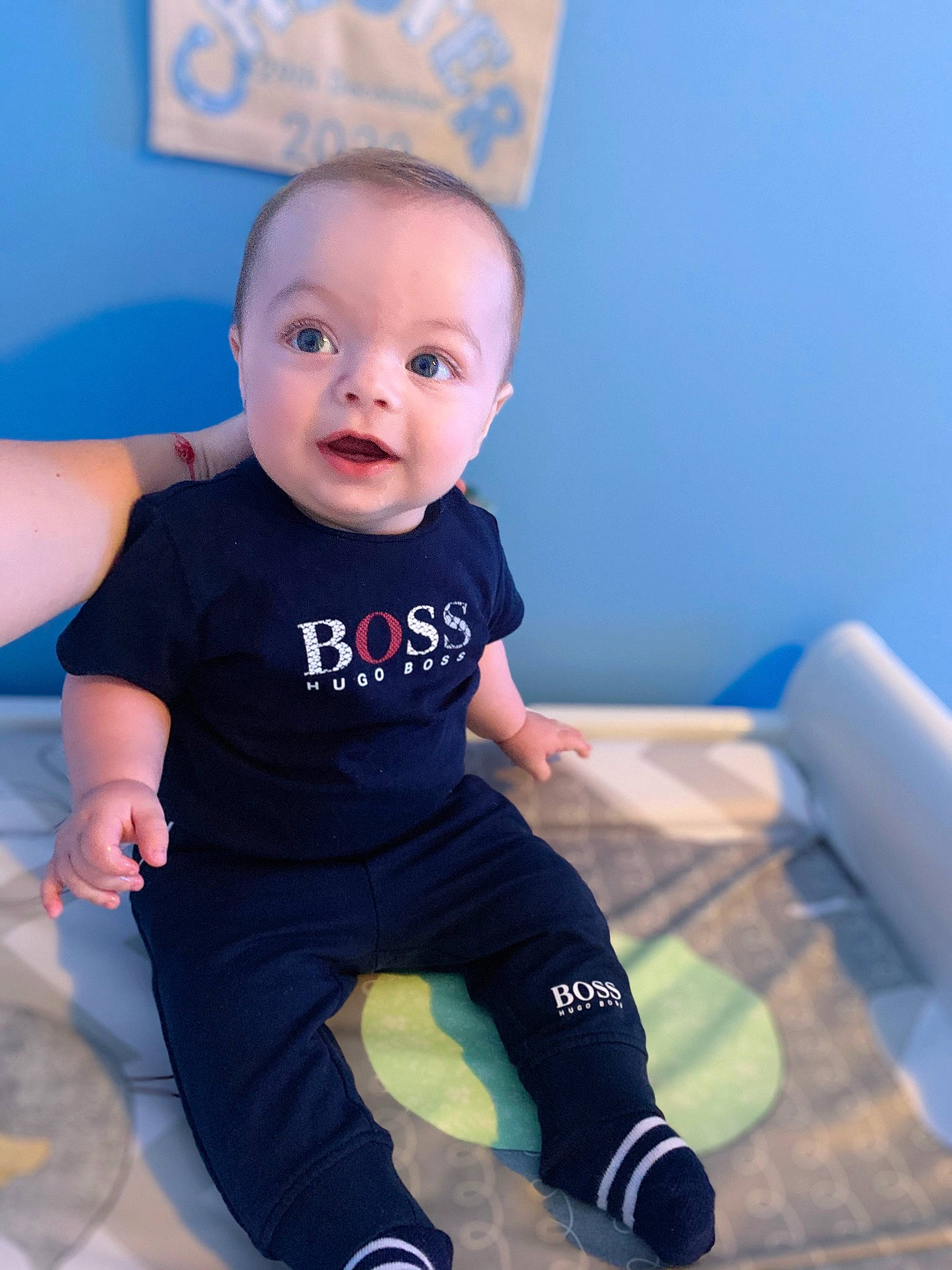 Chester is registered to the contest to win money with this photo: azure, baby, baby_toddler_clothing, blue, cheek, electric_blue, eye, face, flash_photography, fun, hairstyle, happy, head, human_body, knee, person, sleeve, sportswear, standing, surprise