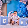 baby, balloons, birthday, blocks, blue, bow_tie, celebration, child, cute, decorations, floor, happy, hot_air_balloon, indoor, one_year_old, photography, portrait, smiling, suspenders, teddy_bear