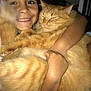 Marty Rodriguez is registered to the contest to win money with this photo: child, cat, orange_cat, hugging, smiling, indoor, close_up, fluffy, pet, cute, happy, face, arms, fur, cozy, bed, blanket, person, animal, comfort