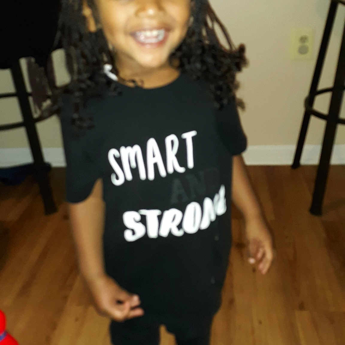 Mustafa is registered to the contest to win money with this photo: child, cool, footwear, joint, joy, person, shoe, shoulder, sleeve, smile, standing, t_shirt, toddler