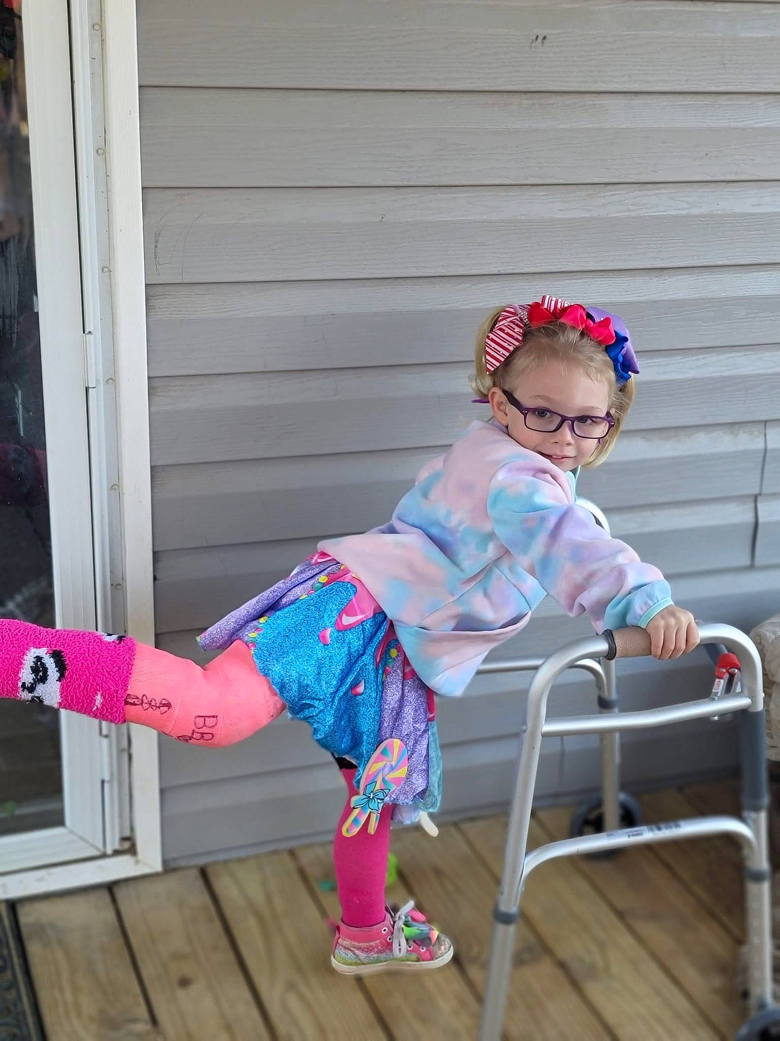 Paisley joined the competition — help win amazing prizes! baby_toddler_clothing, child, electric_blue, eyewear, fashion_accessory, goggles, human_leg, leisure, magenta, pattern, person, personal_protective_equipment, pink, purple, sandal, sitting, sleeve, sock, thigh, toddler