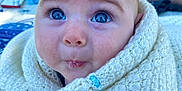 Viteli participe au concours pour gagner de l'argent avec cette photo : baby, blanket, blue_eyes, child, close_up, cute, drool, expression, face, human, infant, knitted, outdoor, person, portrait, sitting, soft_texture, sunlight, wrapped, young