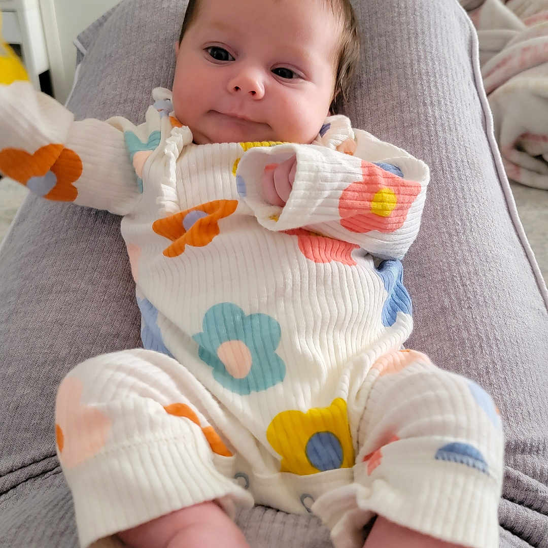 Maddie is registered to the contest to win money with this photo: baby, bodypart, computerhardware, couch, cushion, electronics, face, finger, furniture, hand, hardware, head, homedecor, monitor, newborn, person, photography, portrait, screen, tv