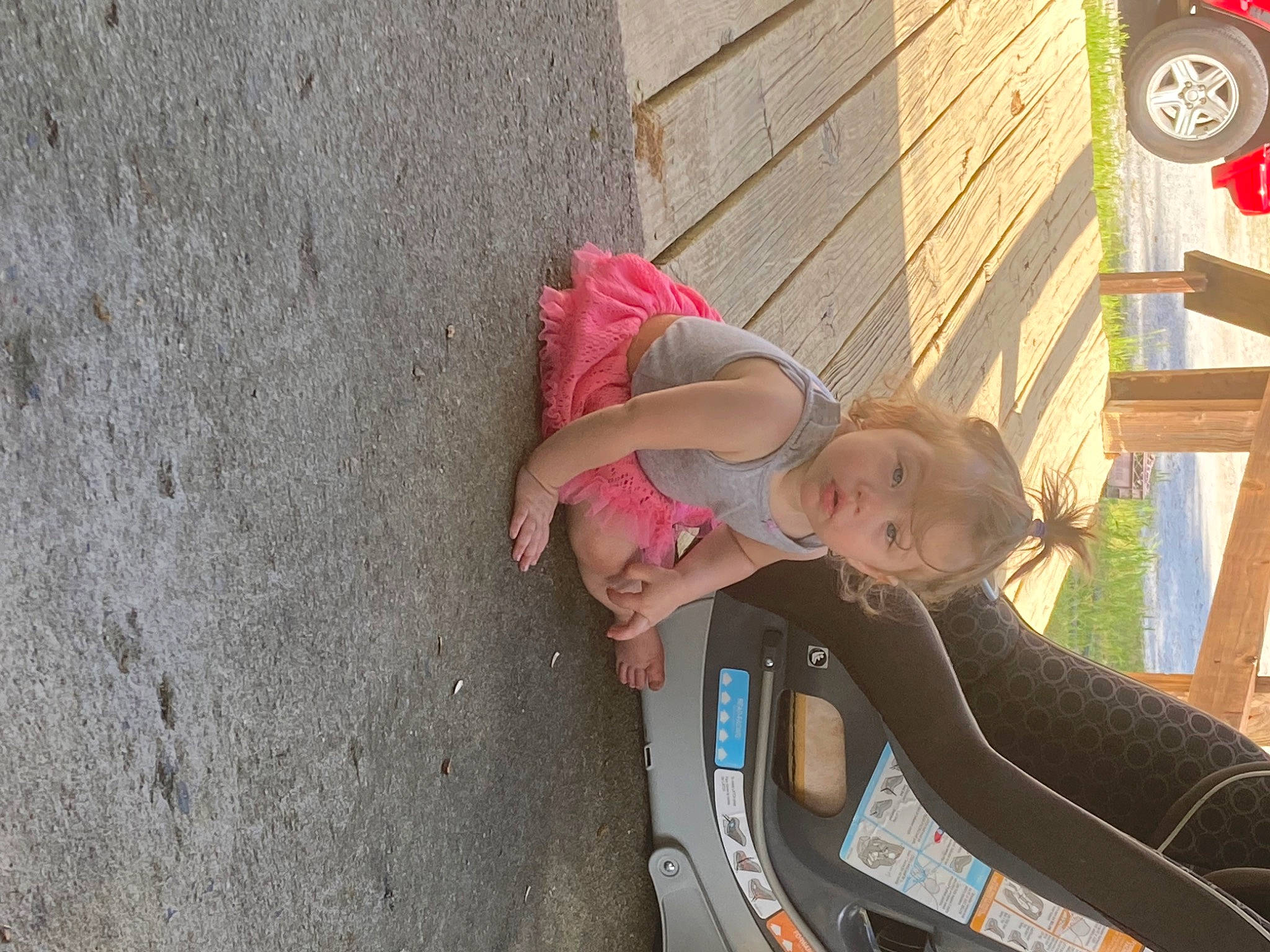 Brookelyn is registered to the contest to win money with this photo: automotive_exterior, automotive_tire, baby, car, dress, fun, hand, happy, leg, leisure, motor_vehicle, person, skin, smile, tire, toddler, tree, vehicle, vehicle_door, wheel