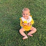Avery is registered to the contest to win money with this photo: baby, child, grass, outdoor, yellow_clothing, barefoot, fruit, smiling, sitting, nature, greenery, cute, young_child, sunlight, person, playful, summer, portrait, happy, infant