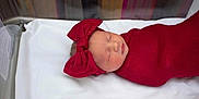 Vivian is registered to the contest to win money with this photo: baby, baby_girl, child, closeup, cute, headband, hospital_bassinet, indoors, infant, newborn, newborn_care, peaceful, portrait, red_blanket, red_bow, resting, sleeping, soft, swaddled, white_sheet
