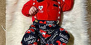 Brenden is registered to the contest to win money with this photo: baby, infant, heart_shaped_sunglasses, sunglasses, bow_tie, bandana, suspenders, red_outfit, valentines_theme, fur_rug, blanket, lying_down, portrait, cute, accessory, red_socks, patterned_pants, carpet, hat, hand